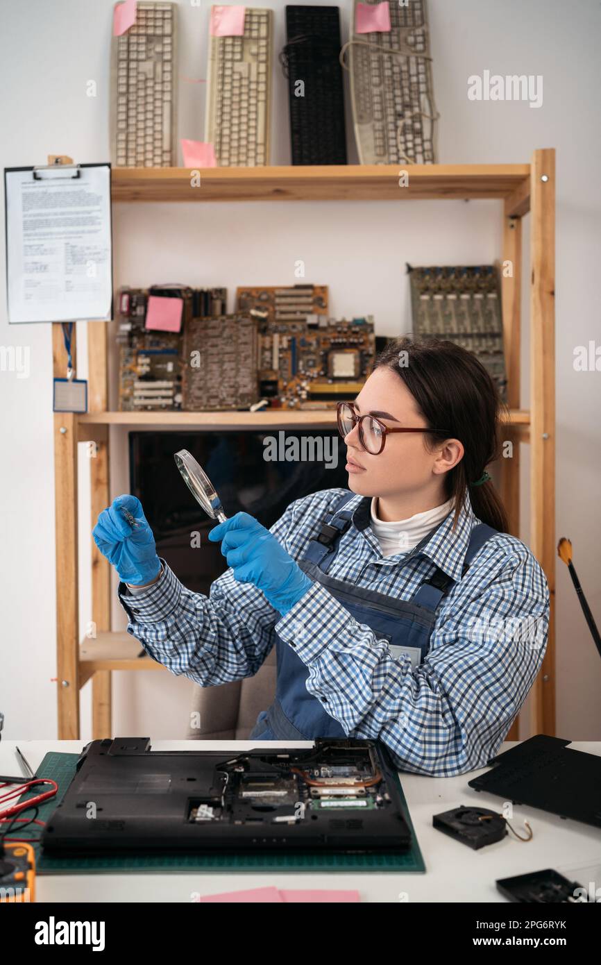The technician holding a CPU of the laptop computer motherboard and ...