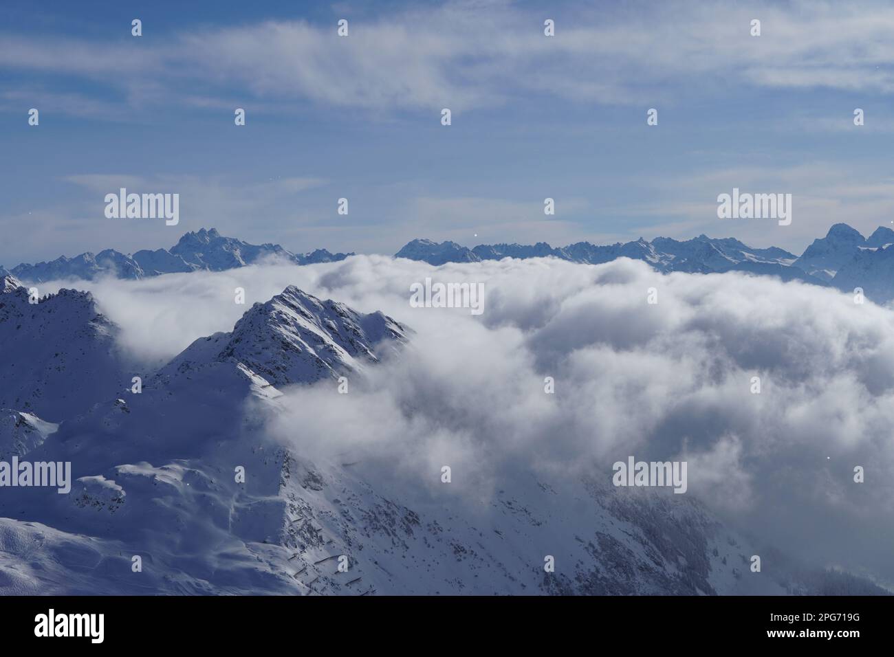 Clouds covering snow capped mountains hi-res stock photography and ...
