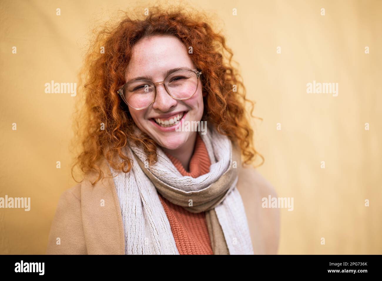 Natural portrait of smiling caucasian ginger woman with freckles and