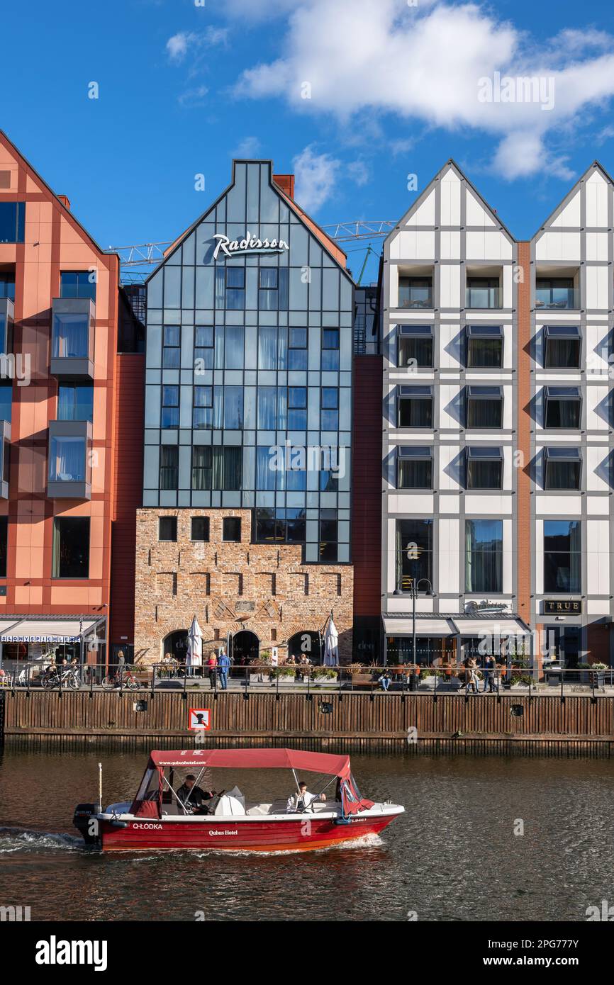 Gdansk, Poland, Radisson Hotel and Suites on the Granary Island and boat on Motlawa River. Stock Photo