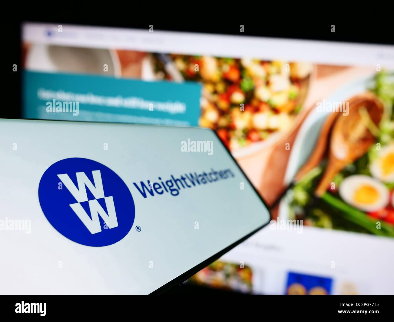 Mobile phone with logo of WW International Inc. (Weight Watchers) on