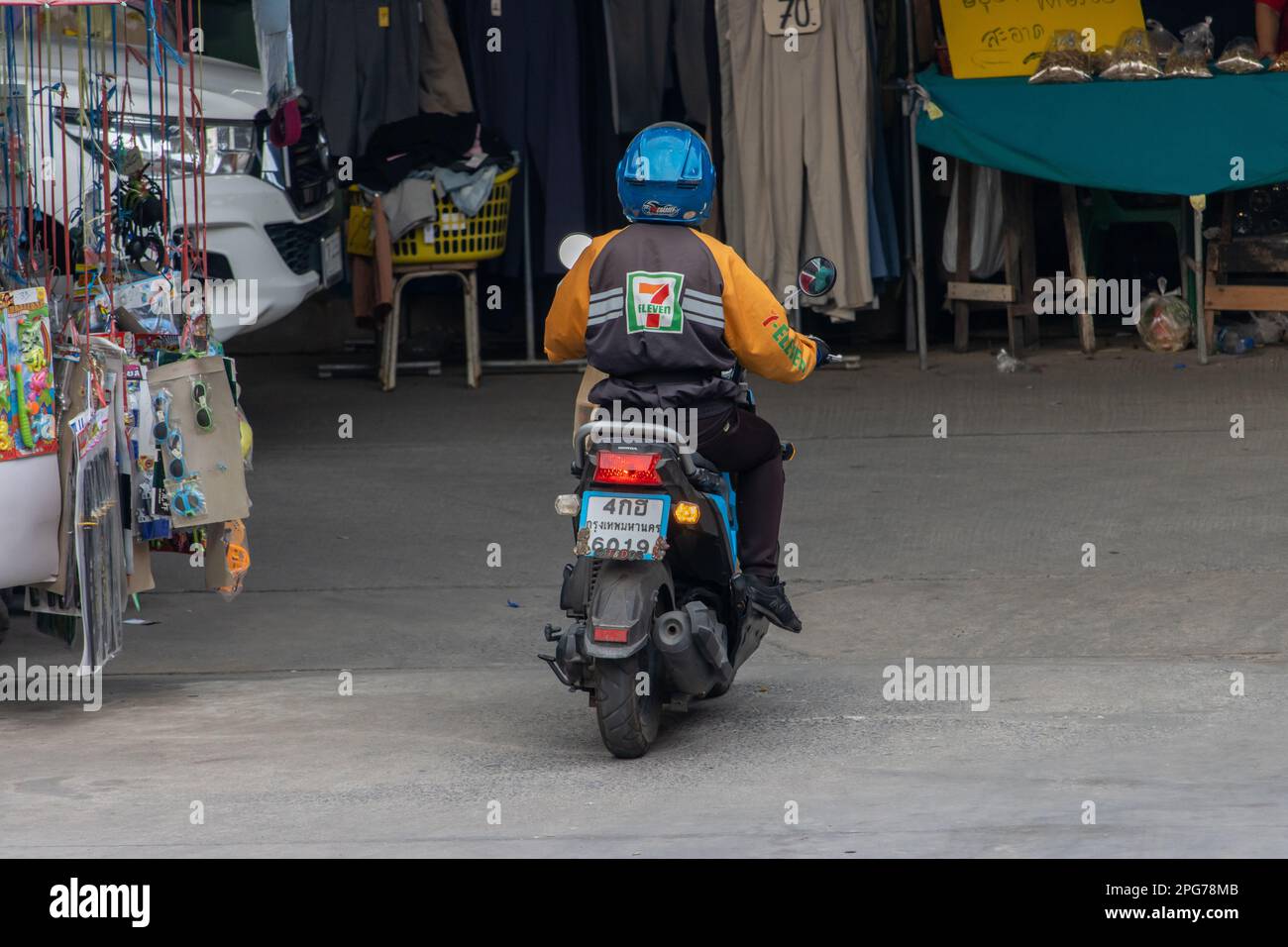 SAMUT PRAKAN, THAILAND, FEB 17 2023, A 7-eleven delivery man rides a ...