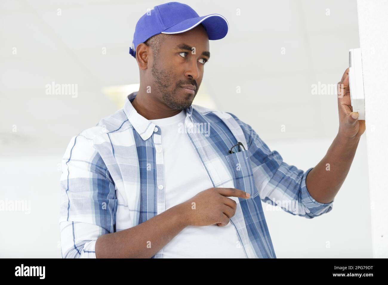 installing a programmable room thermostat Stock Photo Alamy