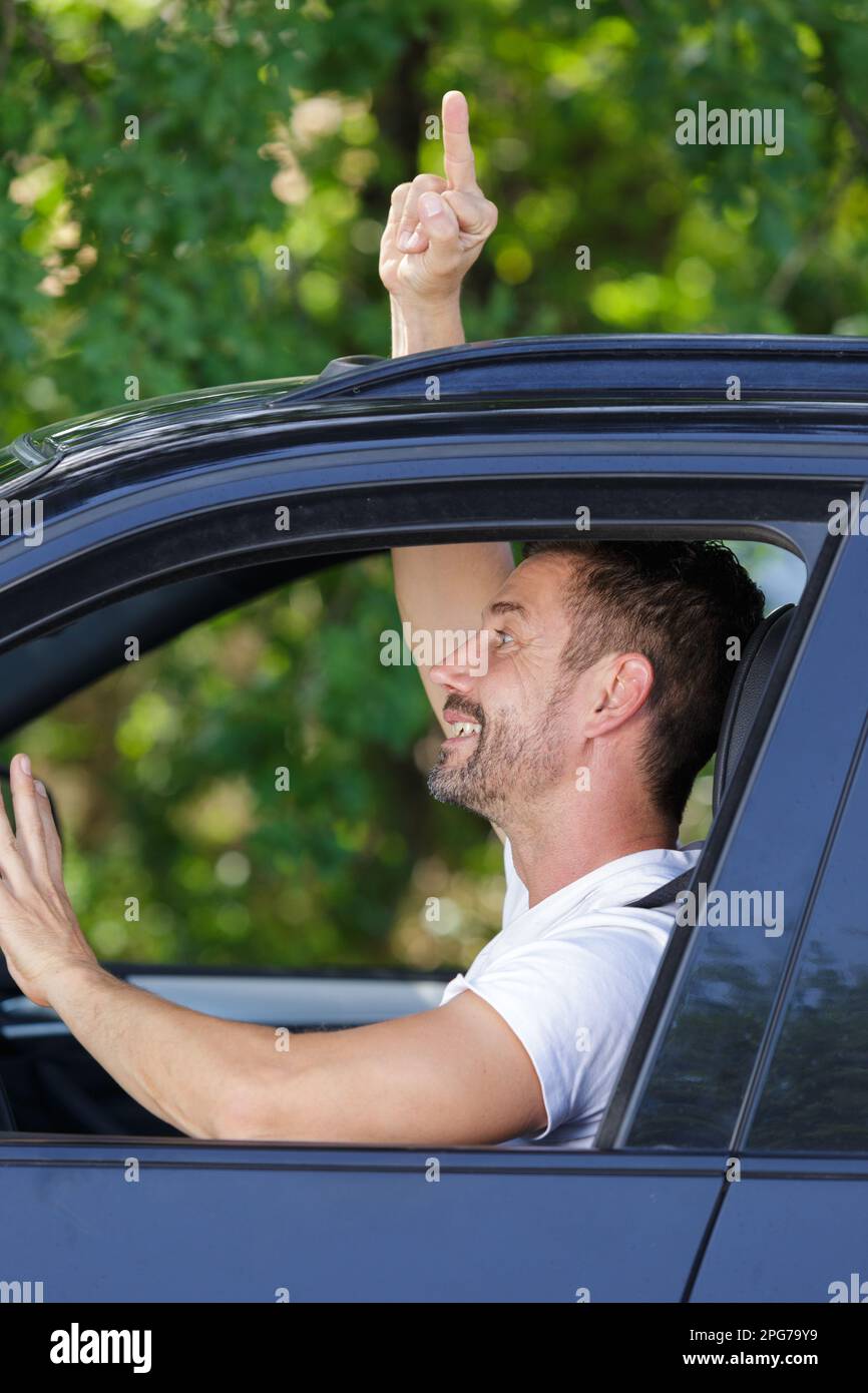 an driving and showing middle finger in car Stock Photo - Alamy