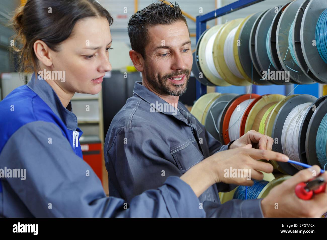 woman and man working in a factory Stock Photo