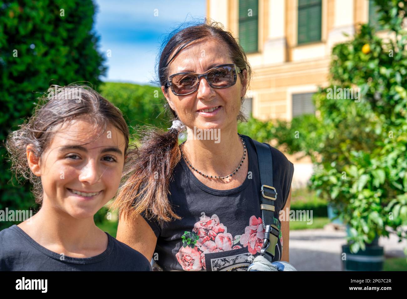 Vienna family tourism. A young girl with her mother visiting Schonbrunn