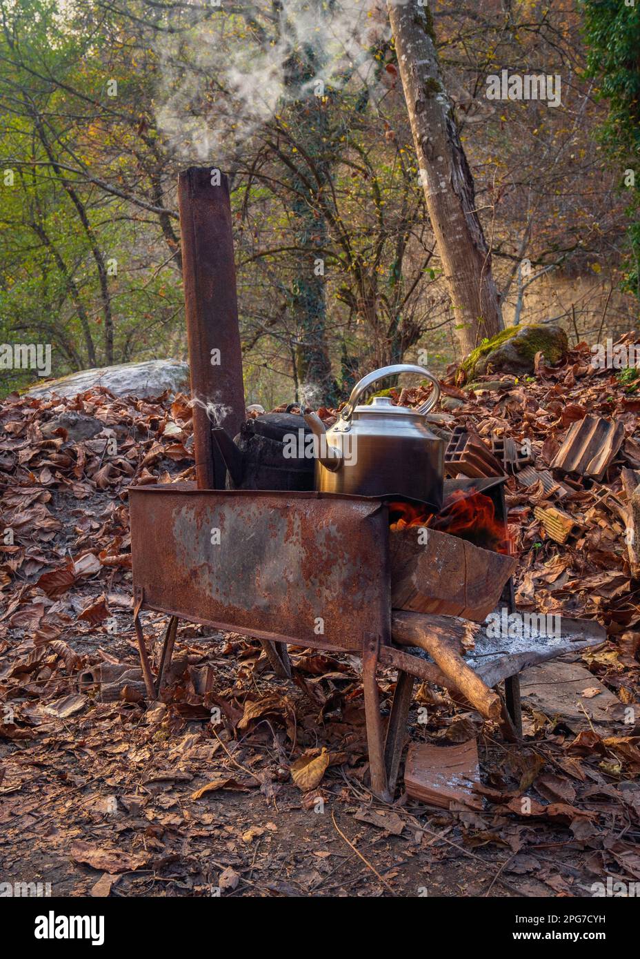 Kettles are boiled on a wood burning stove Stock Photo Alamy