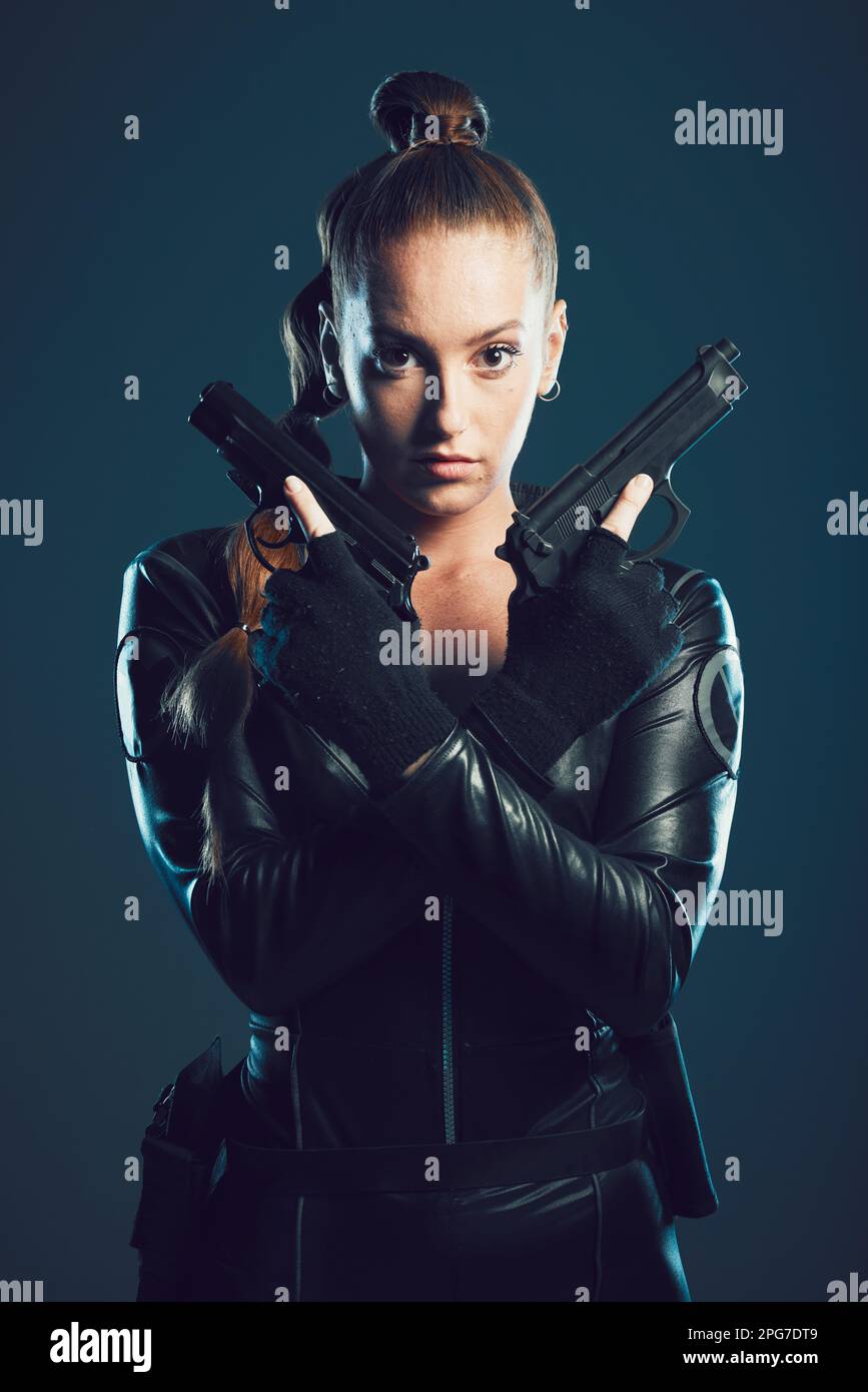Woman, gun and assassin in studio portrait for costume, action or