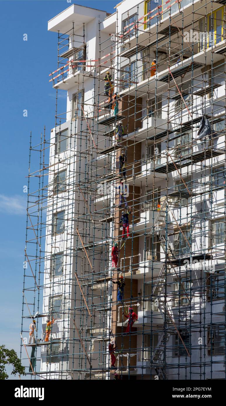 Construction workers on scaffolding building a new apartment building in central Rosebank