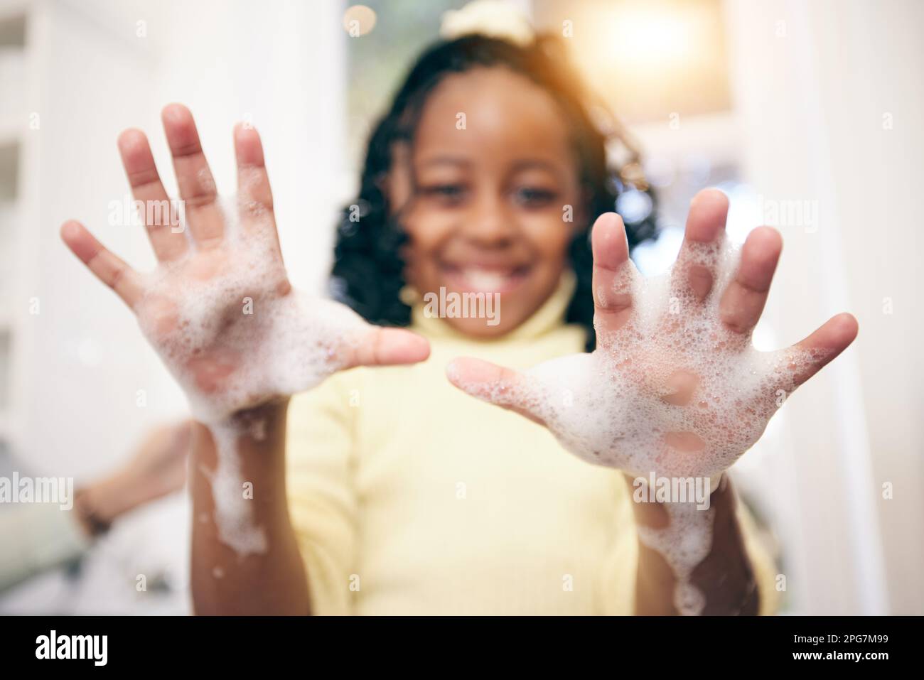 Washing hands, girl and portrait with soap foam in a bathroom with