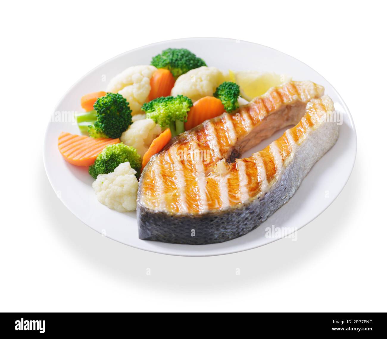 plate of grilled salmon steak with vegetables isolated on white ...