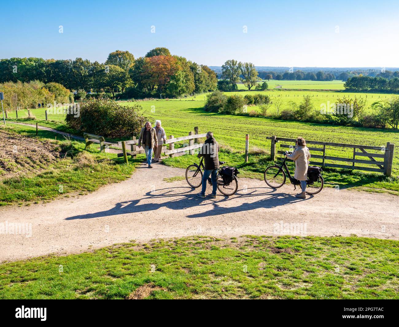Senior bicyclists and walkers in nature near town of Ootmarsum, Overijssel, Netherlands Stock Photo