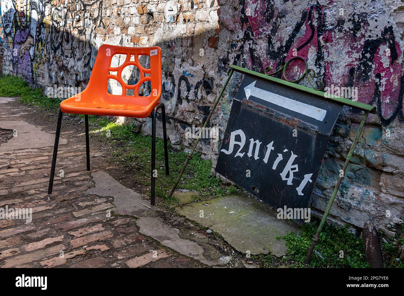 Plastic Chair In Orange, RAW Area, Former Reichsbahnausbesserungswerk, Friedrichshain, Berlin, Germany Stock Photo