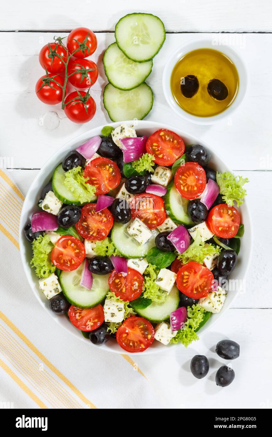 Stuttgart, Germany - December 27, 2022: Greek Salad With Fresh Tomatoes Olives And Feta Cheese Healthy Food Eating Portrait From Top On Wooden Board I Stock Photo