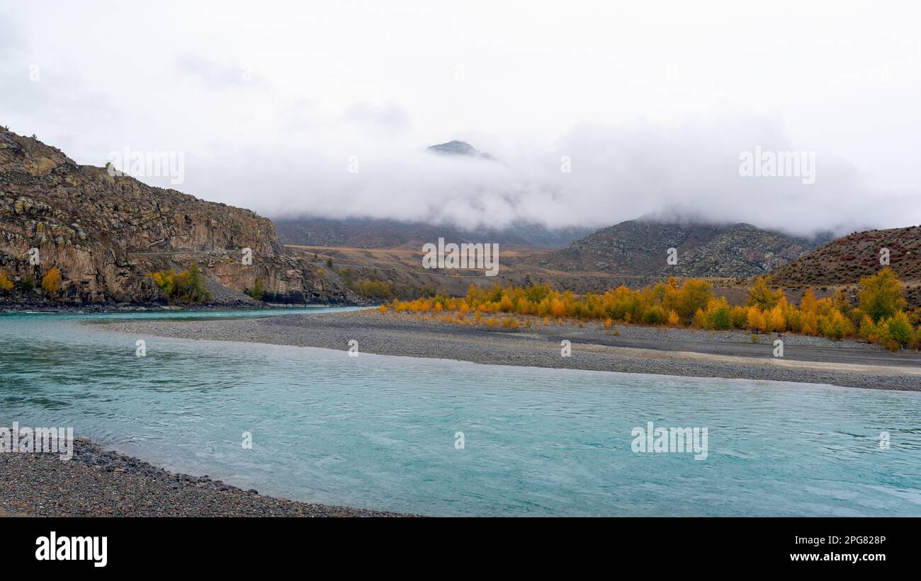 Morning fog among the mountains near the Katun River and the road in Altai in autumn. Stock Photo