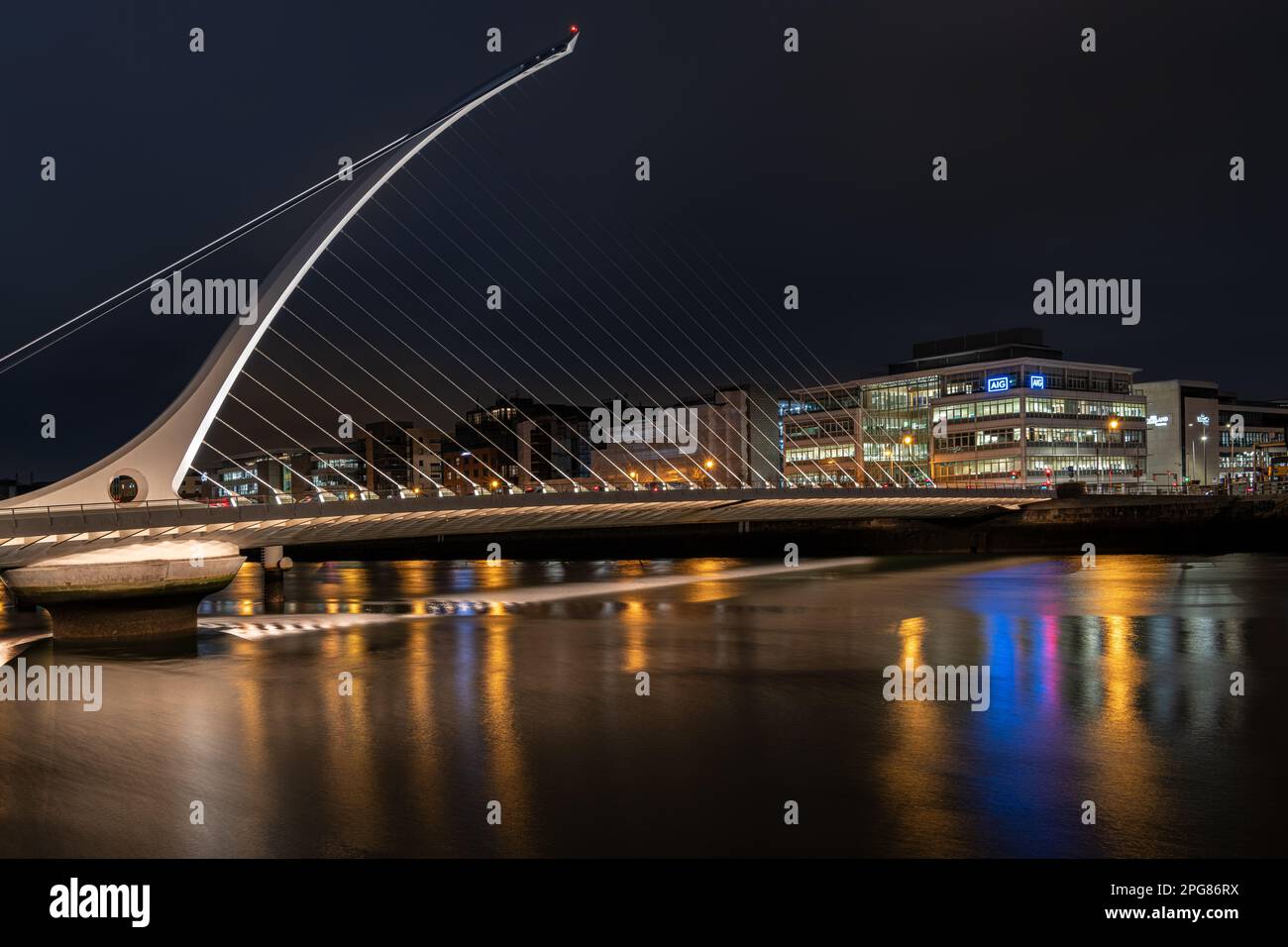 The Samuel Beckett Bridge over the River Liffey illuminated at night ...