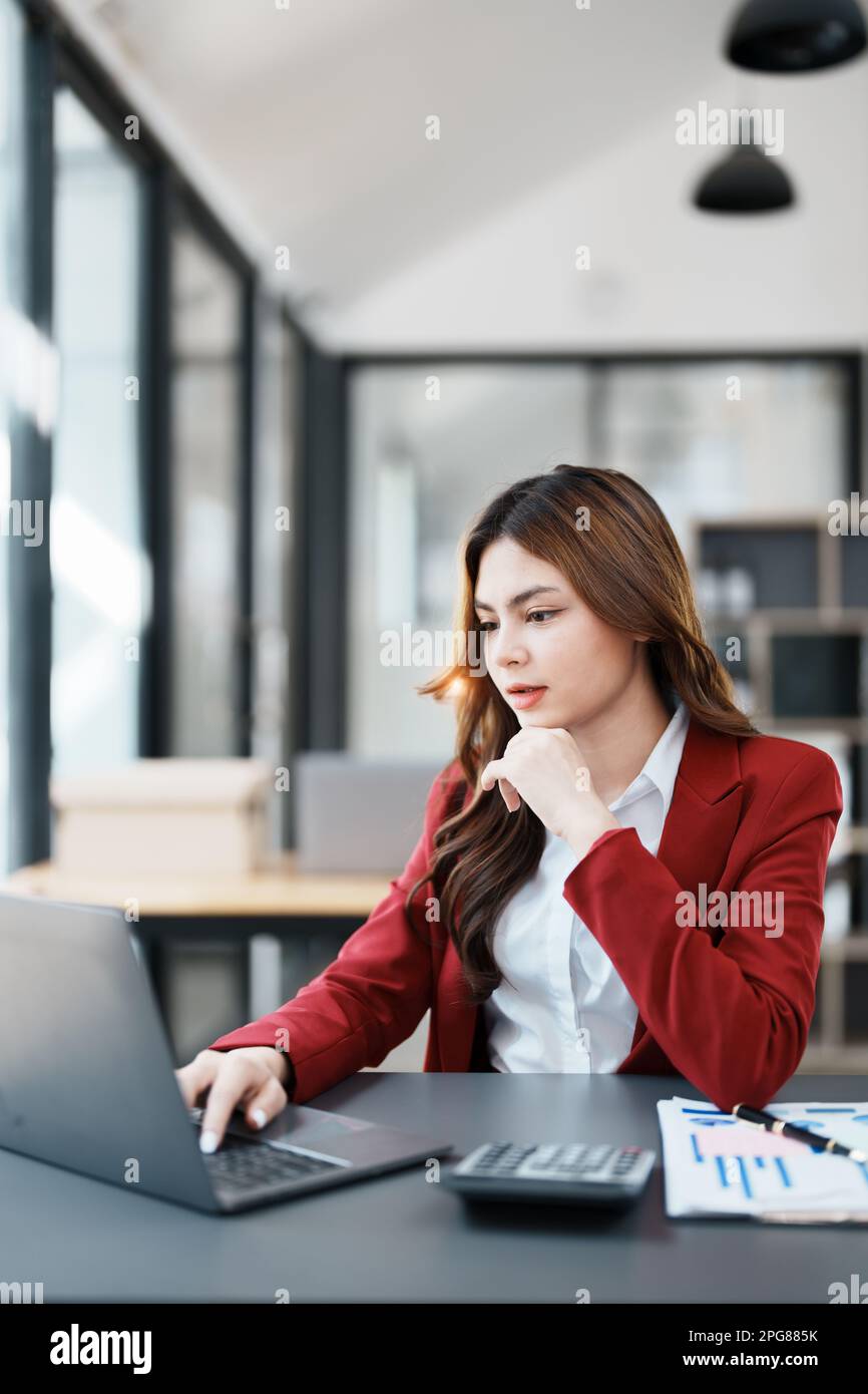 Beautiful young teen asian businesswoman using computer laptop and ...