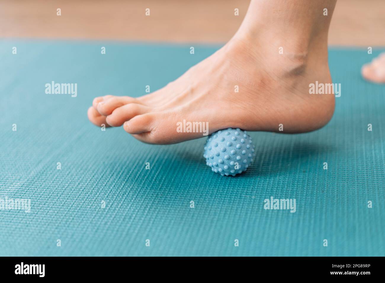 Lady kneading her feet with myo fascial release ball Stock Photo Alamy