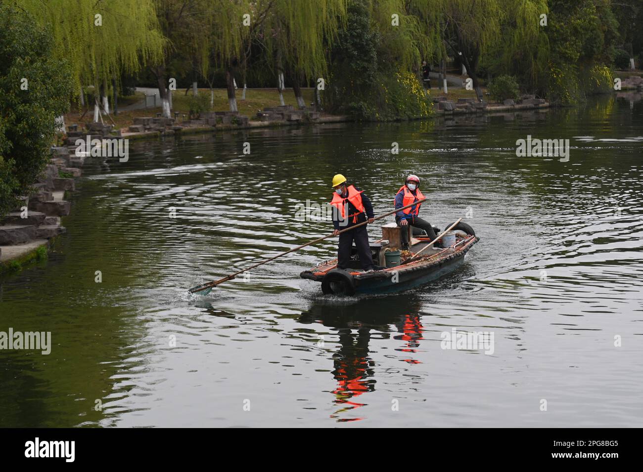 (230321) -- HANGZHOU, March 21, 2023 (Xinhua) -- Workers clean the water surface on Dongtai river in Beilun District of Ningbo, east China's Zhejiang Province, March 16, 2023. Zhejiang Province has been taking water environment management as top priority in ecological construction, elevating the water quality of hundreds of lakes and rivers and establishing waterfront civic activity sites. (Xinhua/Huang Zongzhi) Stock Photo
