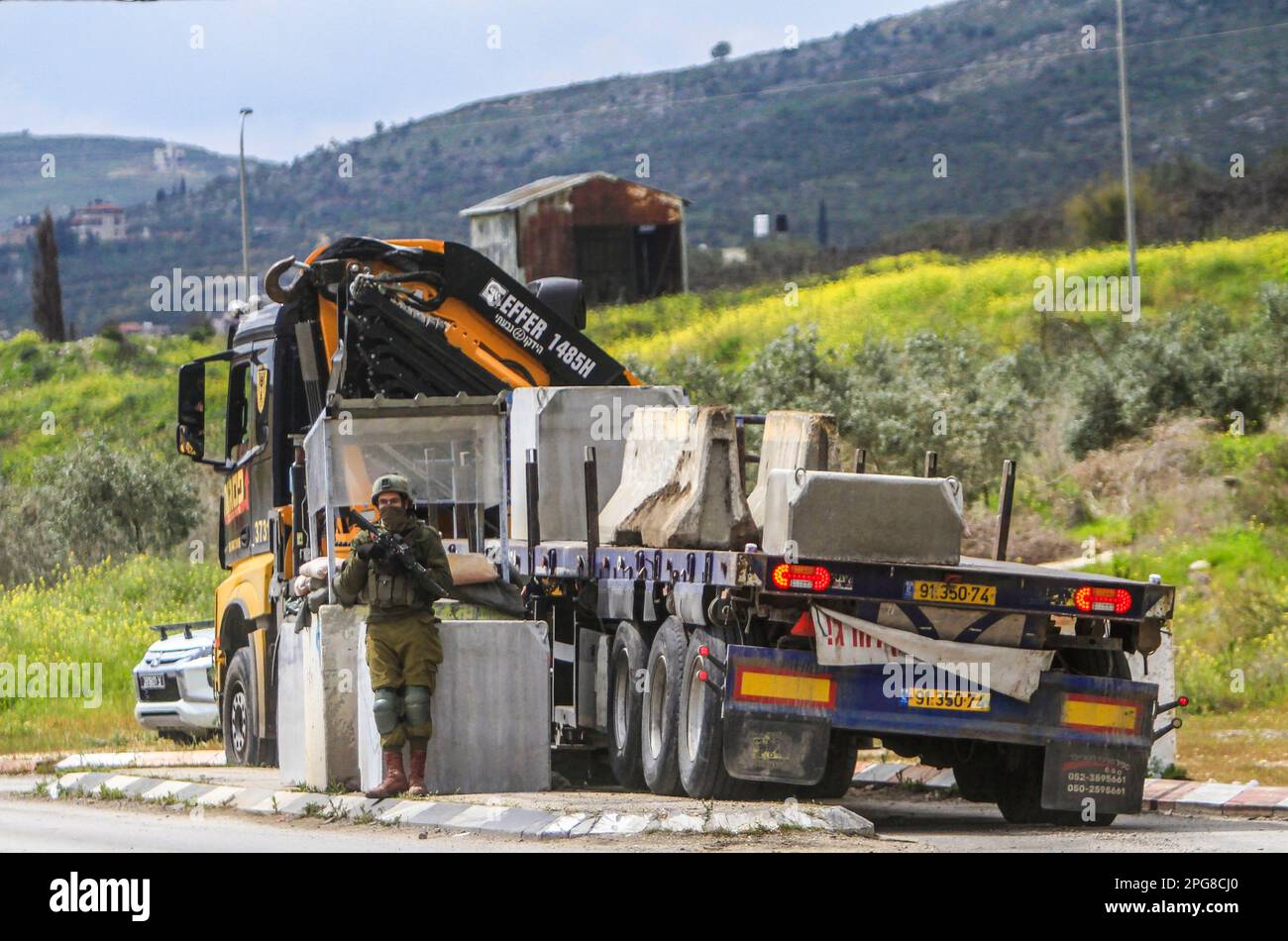 Nablus, Palestine. 21st Mar, 2023. Israeli army forces set up a new military checkpoint in the town of Hawara, south of Nablus, in the occupied West Bank. Credit: SOPA Images Limited/Alamy Live News Stock Photo