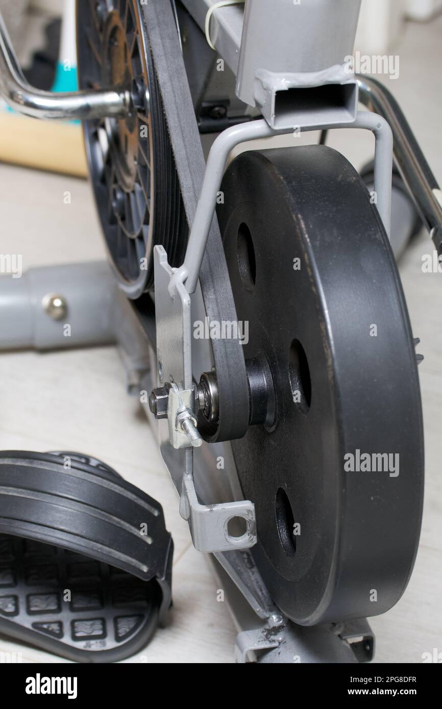 Elements of an exercise bike. Servicing the drive pulley and flywheel