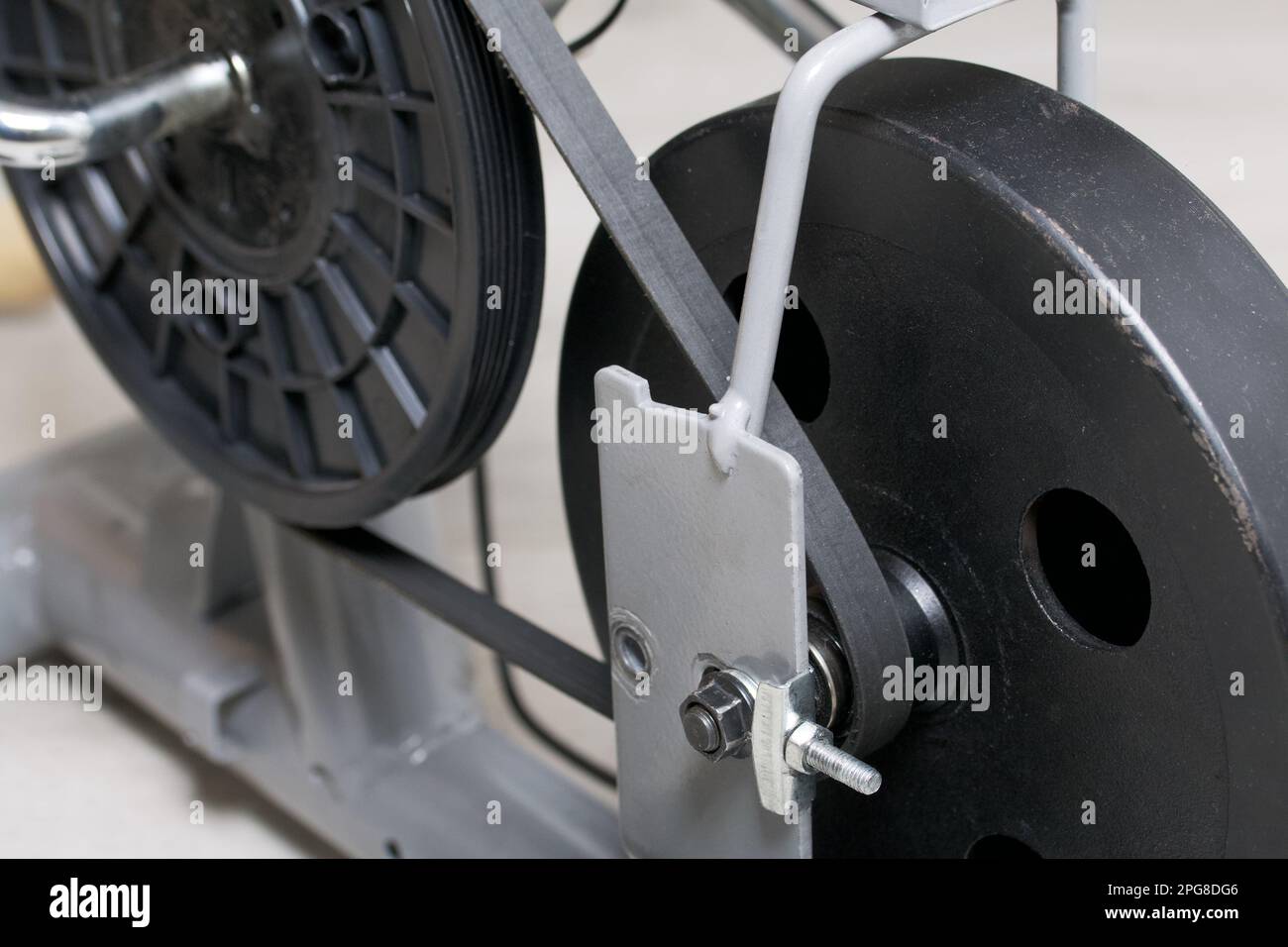 Elements of an exercise bike. Servicing the drive pulley and flywheel