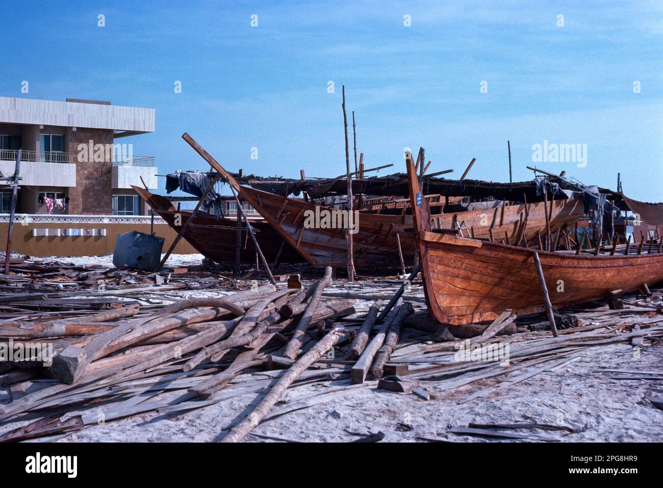 Abu Dhabi UAE 1976 – Dhow building yard at Al Bateen harbour (this area has now been redeveloped) in Abu Dhabi, United Arab Emirates Stock Photo