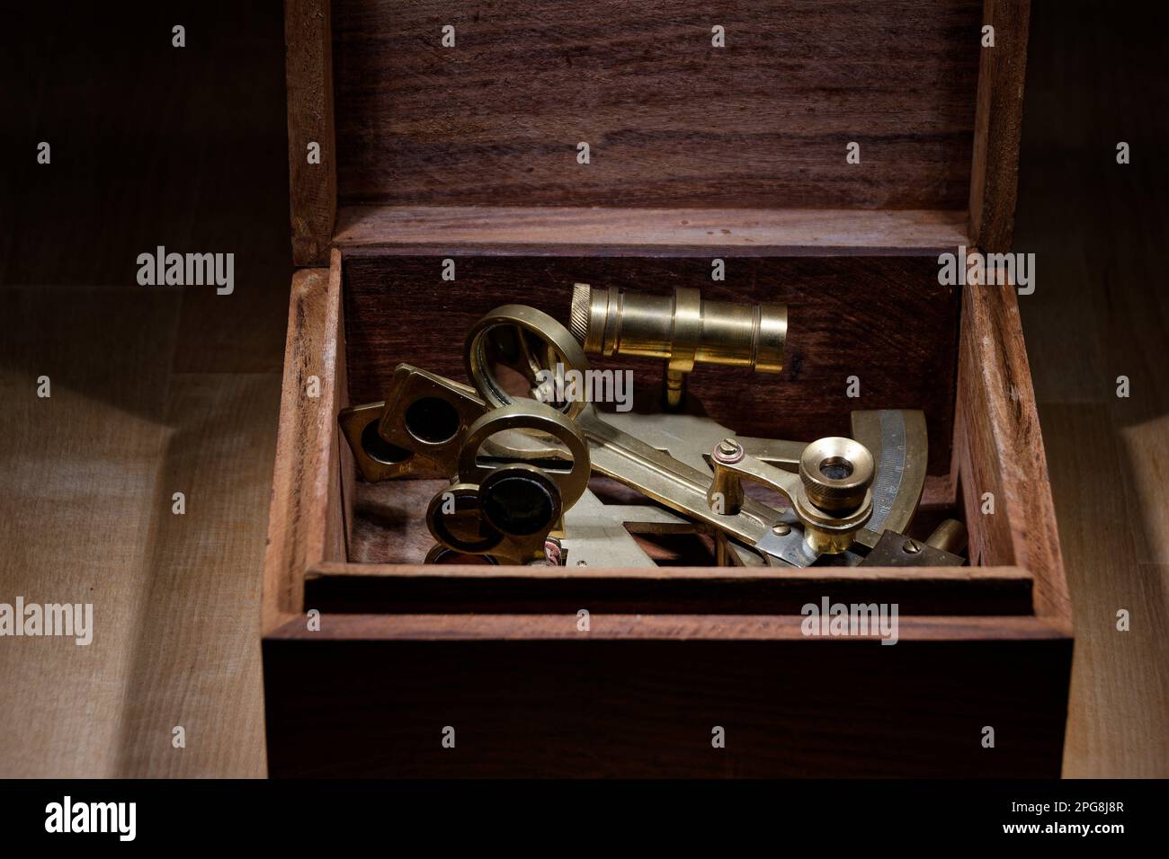 old sextant, spyglass, circle and compass lying on wooden table Stock Photo
