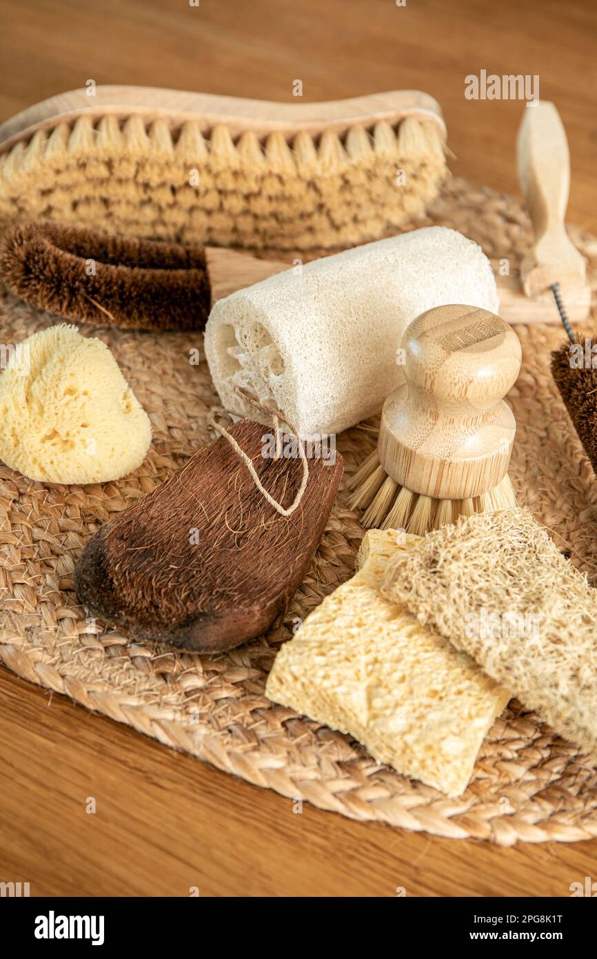 Collection of various cleaning brushes and sponges of various natural materials in home kitchen. Coconut, sisal, bamboo, wood fibers, sea sponge. Stock Photo
