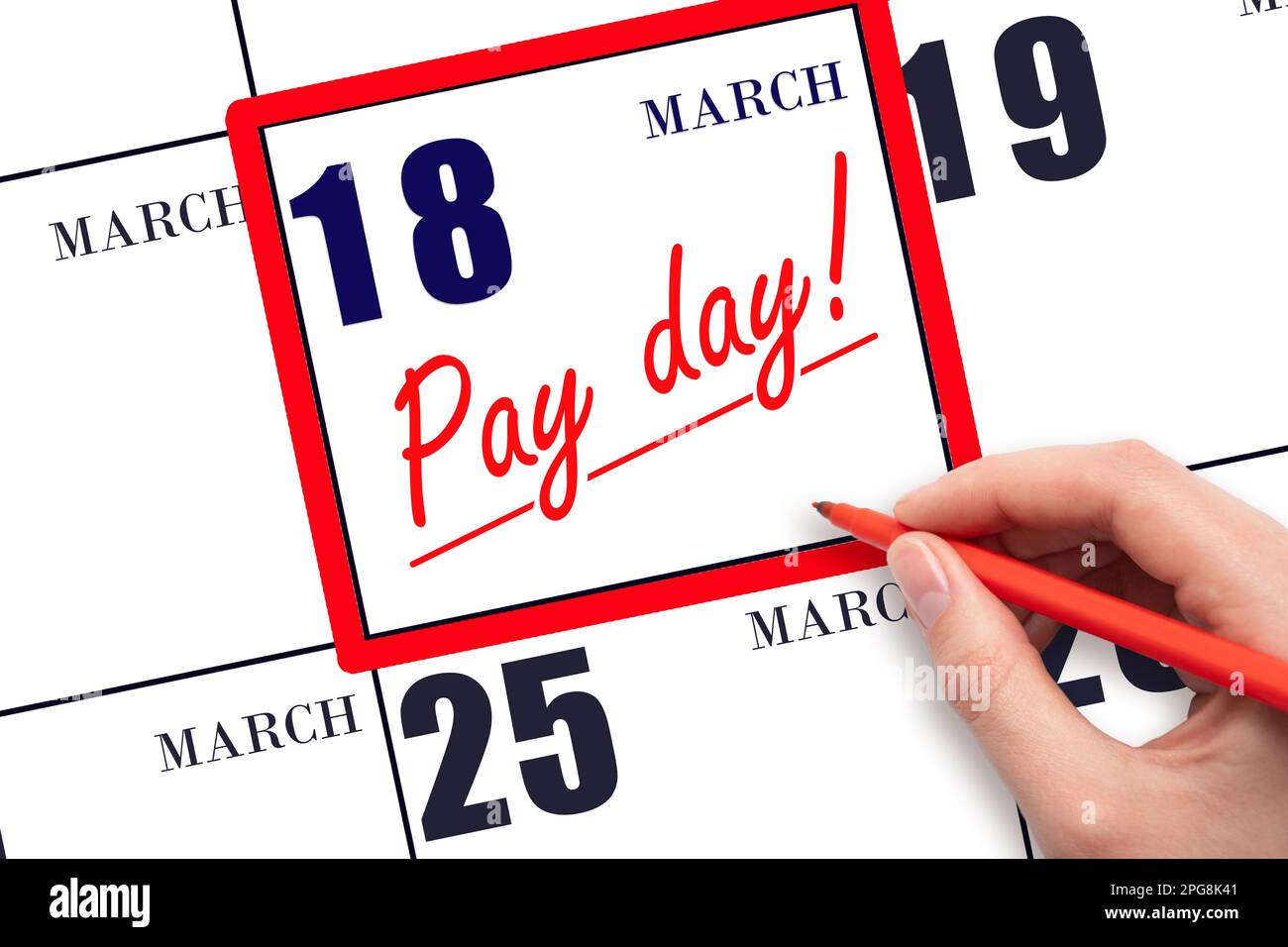 18th day of March. Hand writing text PAY DATE on calendar date March 18 and underline it. Payment due date. Reminder concept of payment. Spring month, Stock Photo