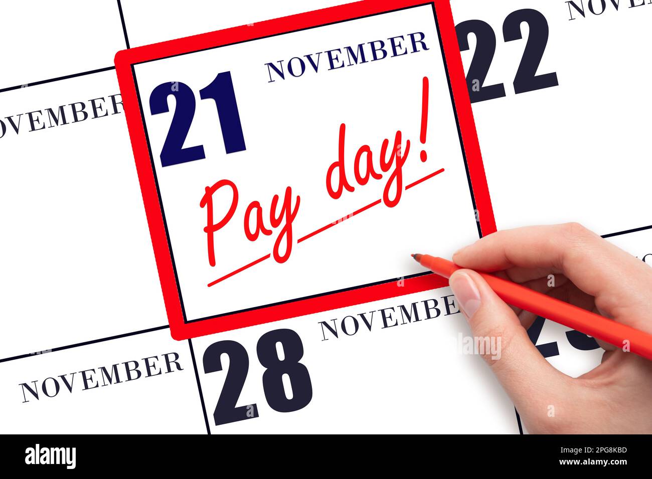 21st day of November. Hand writing text PAY DATE on calendar date November 21 and underline it. Payment due date. Reminder concept of payment. Autumn Stock Photo