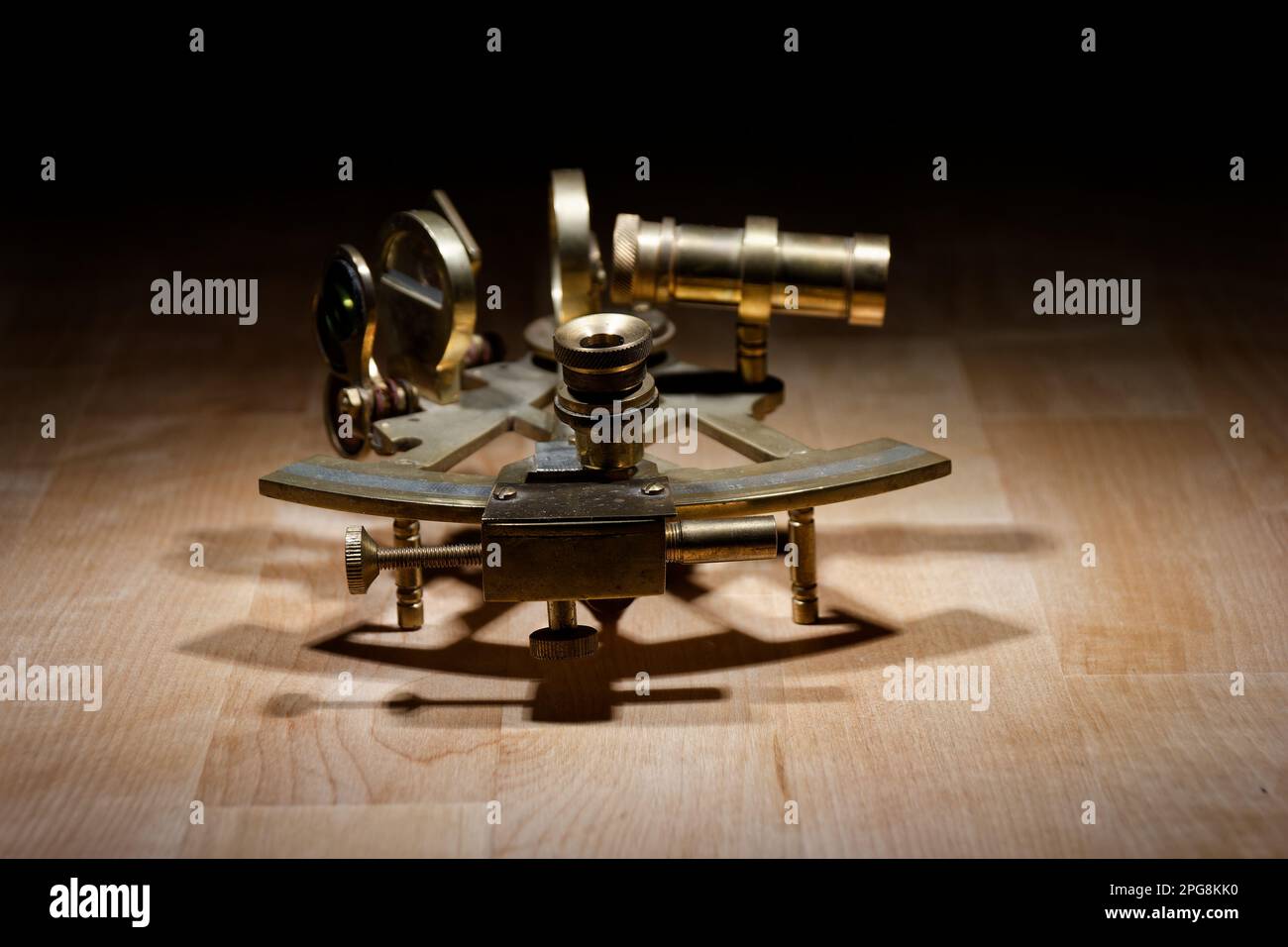 old sextant, spyglass, circle and compass lying on wooden table Stock Photo