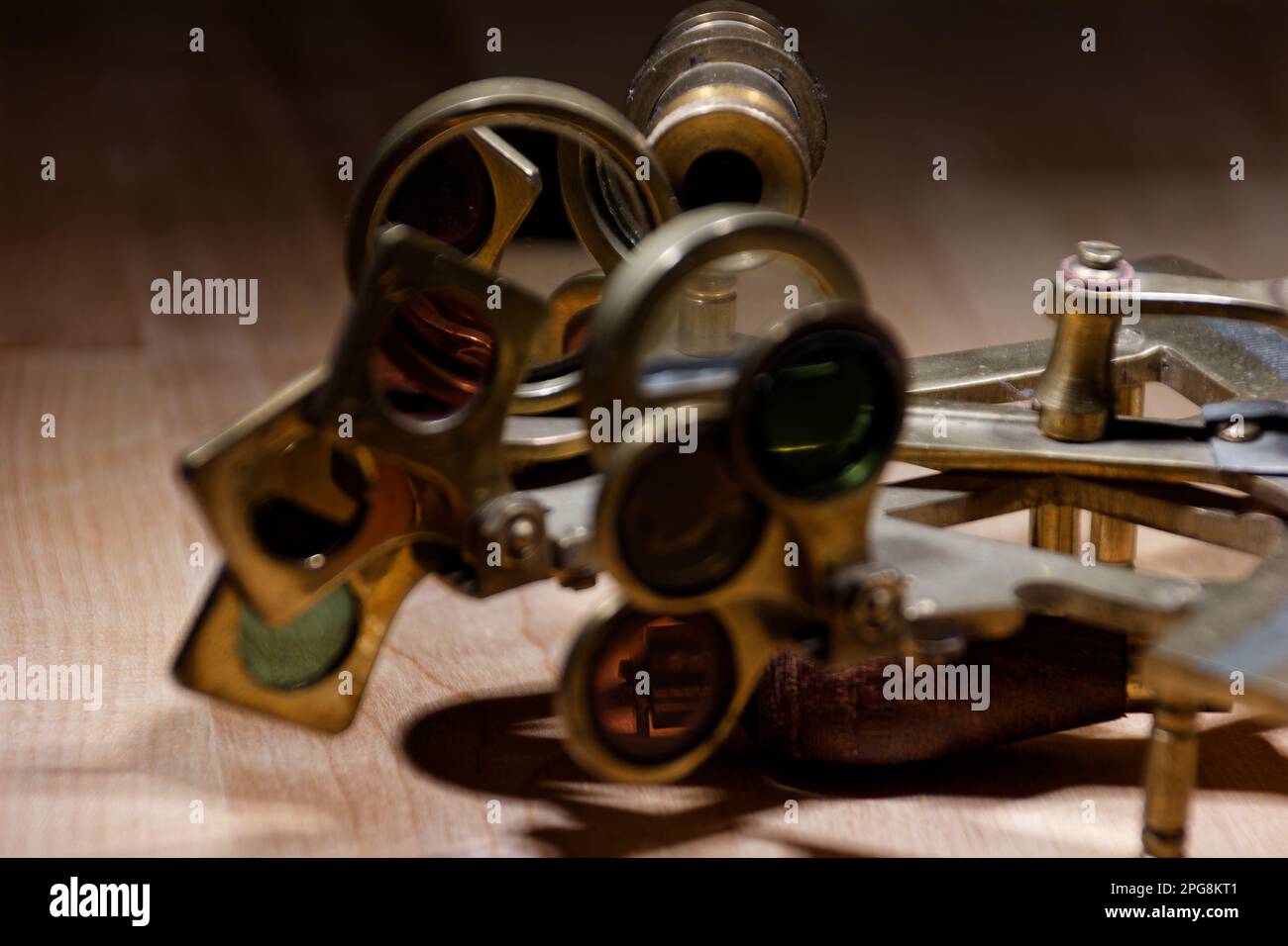 old sextant, spyglass, circle and compass lying on wooden table Stock Photo