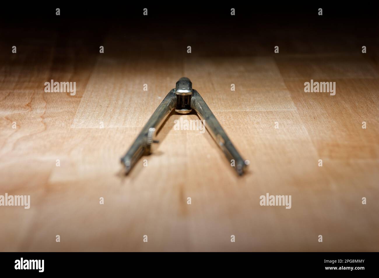 divider. compass for geometric construction lying on wooden table Stock Photo