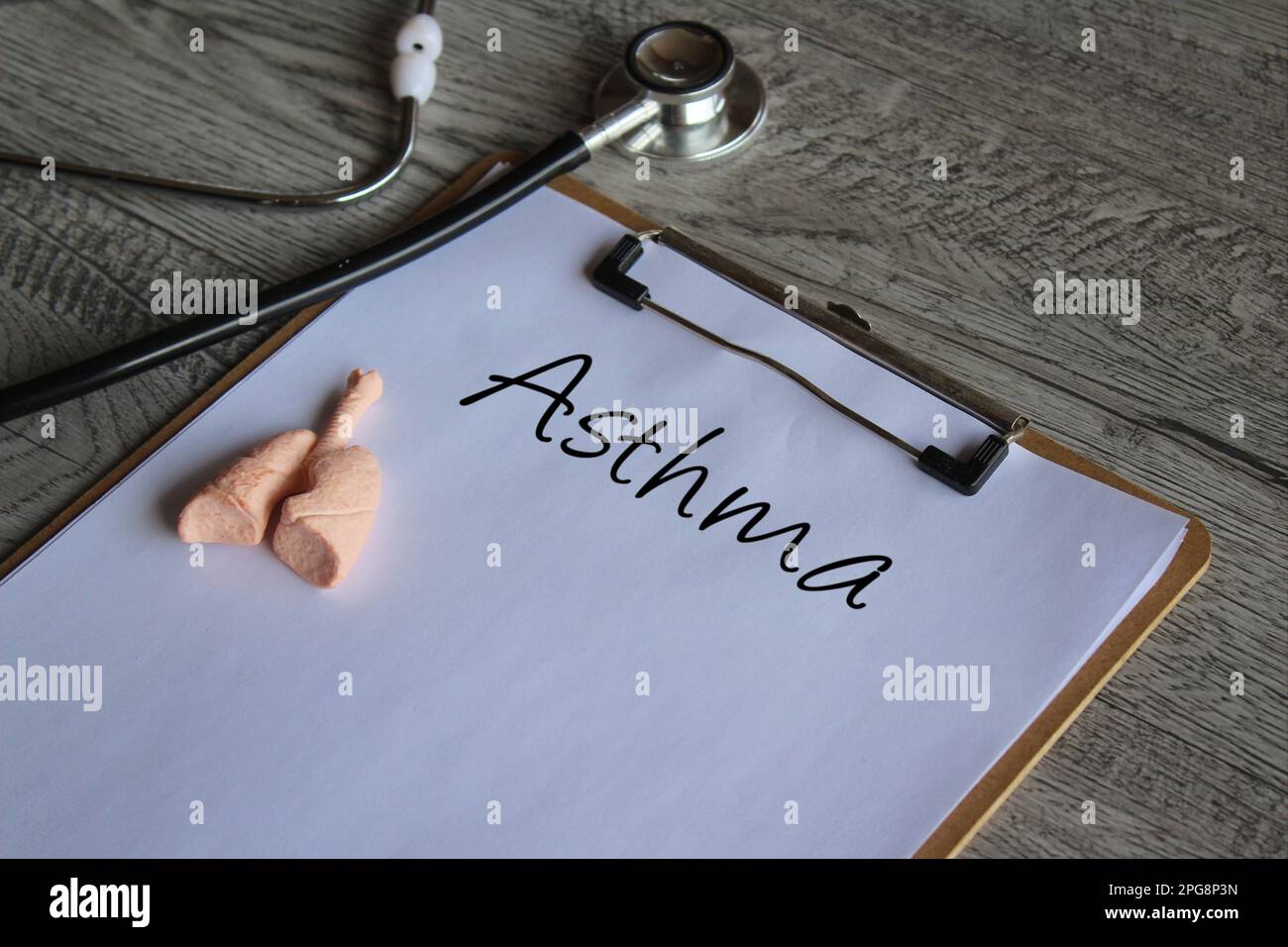 Stethoscope, human lung model and paper clipboard with text Asthma. Medical and healthcare concept Stock Photo