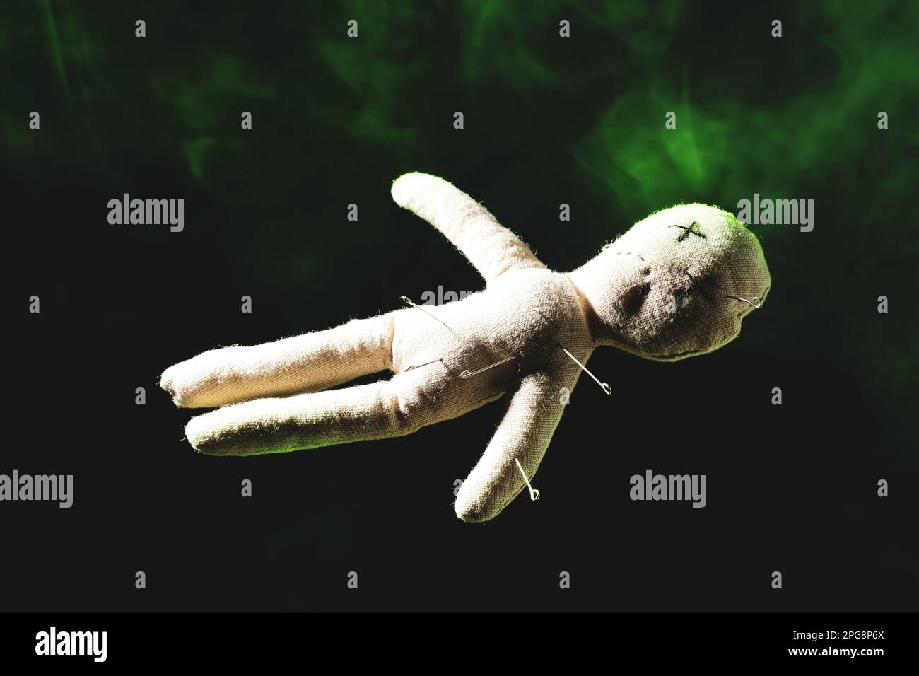 Voodoo doll with pins and smoke on dark background Stock Photo - Alamy