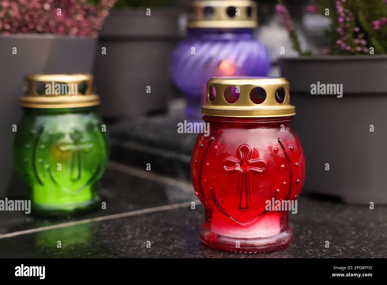 Different grave lanterns on granite surface at cemetery Stock Photo - Alamy
