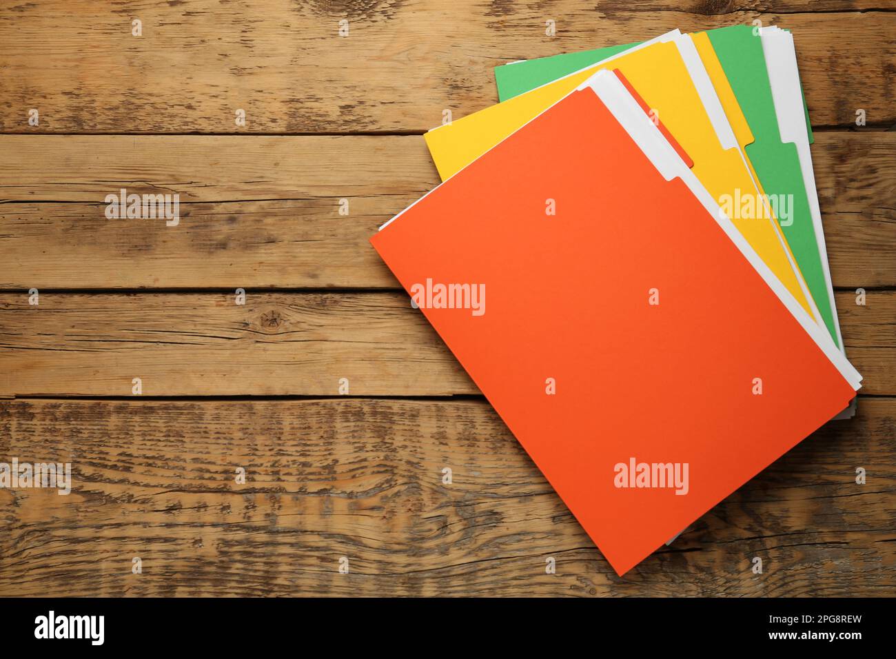 Different files with documents on wooden table, top view. Space for