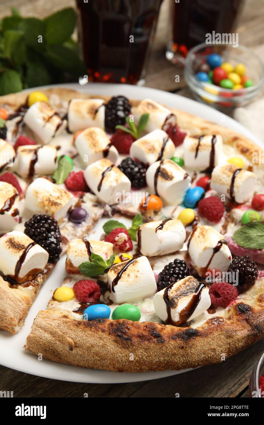 Tasty sweet pizza with berries, marshmallows and candies in