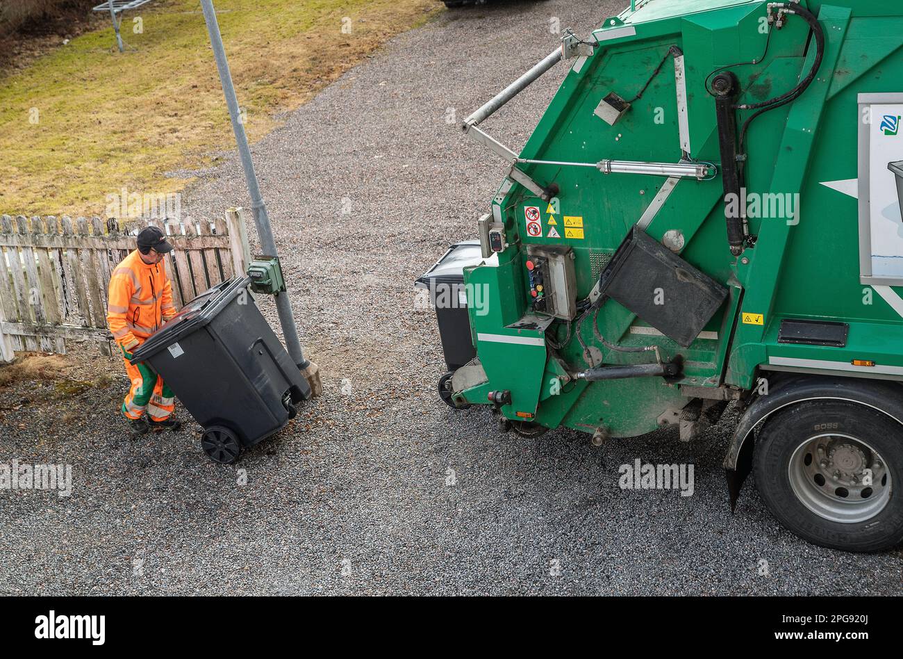 garbage truck driver empty trash in malmkoping sweden Stock Photo
