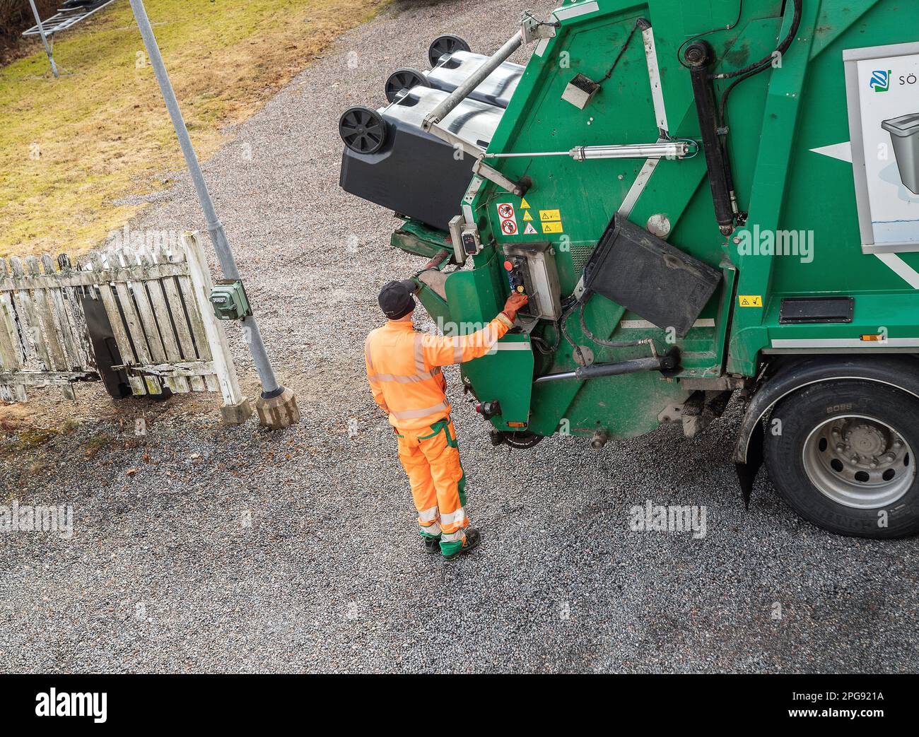 garbage truck driver empty trash in malmkoping sweden Stock Photo