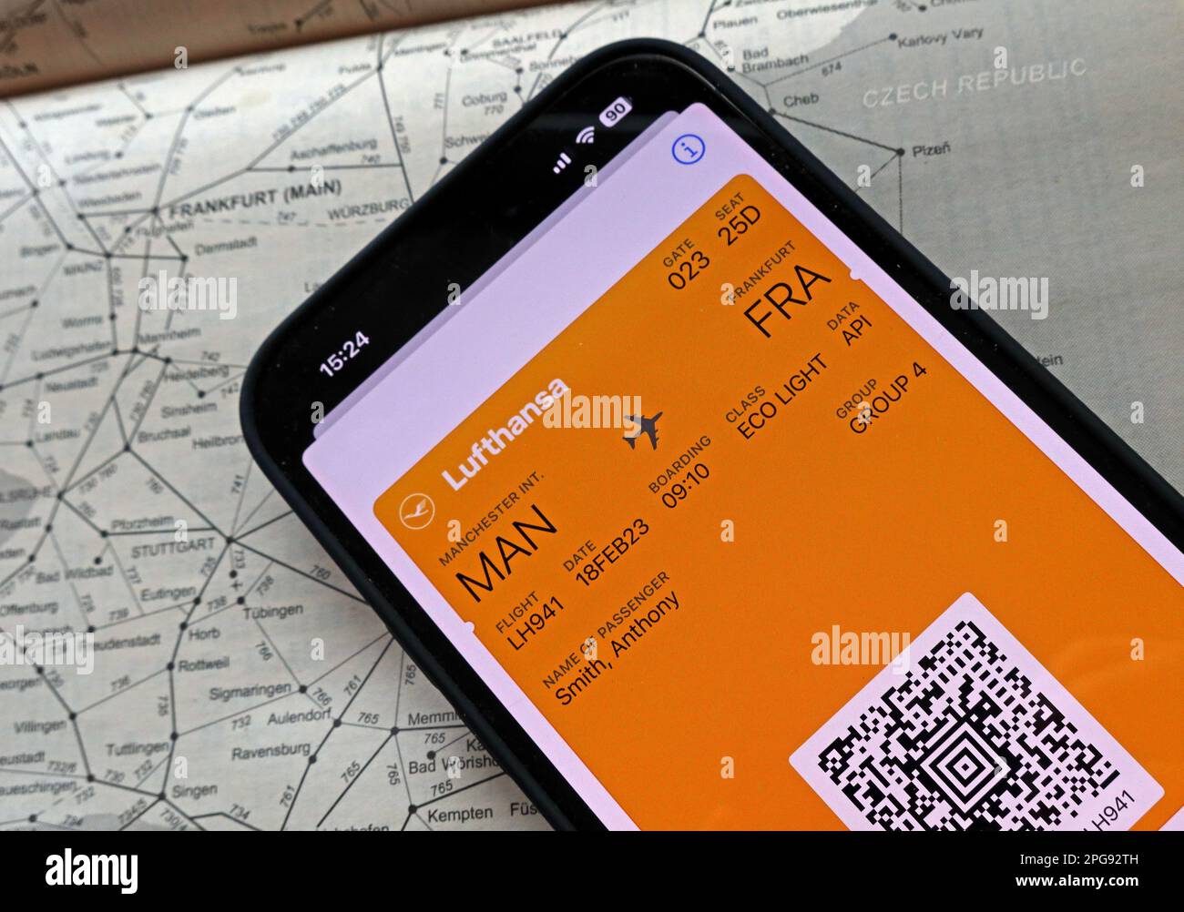 Airplane flight digital boarding pass MAN-FRA on mobile phone, with Lufthansa, and rail transport map of Frankfurt, Germany Stock Photo