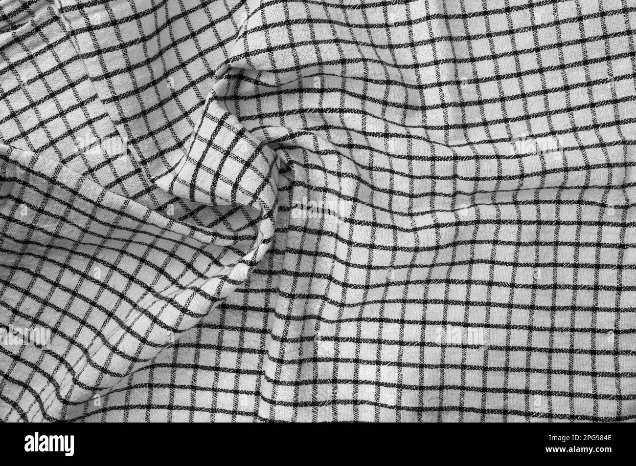 Classic black and white checkered kitchen towel texture. Crumpled