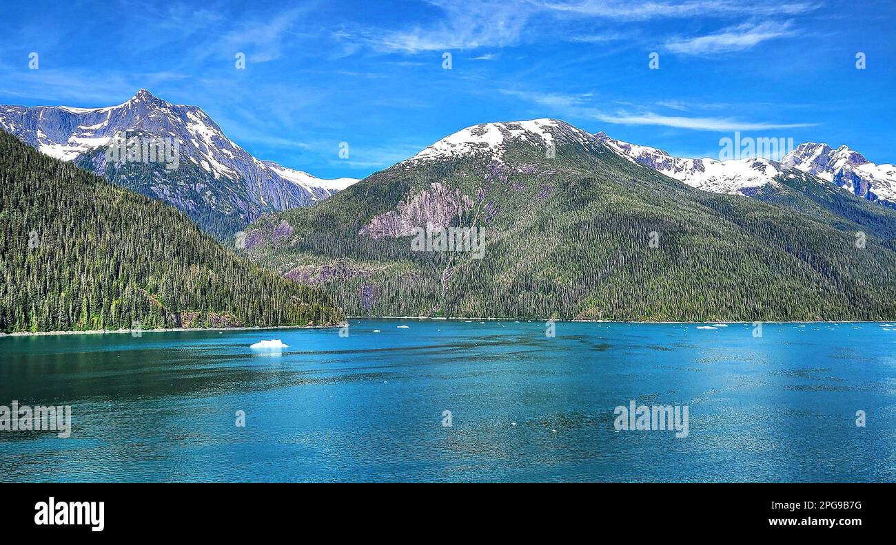 A stunning landscape featuring a tranquil body of water with a majestic ...