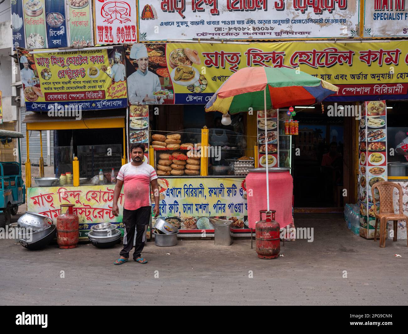 Restaurant workers posing for a photograph outside their business in Murshidabad, West Bengal, India. Stock Photo