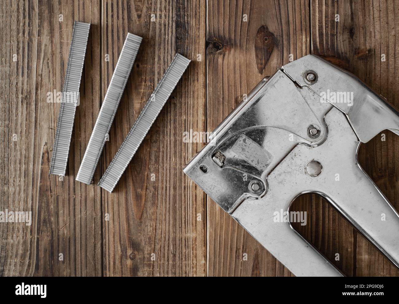 Overhead view of industrial staple gun on wood Stock Photo