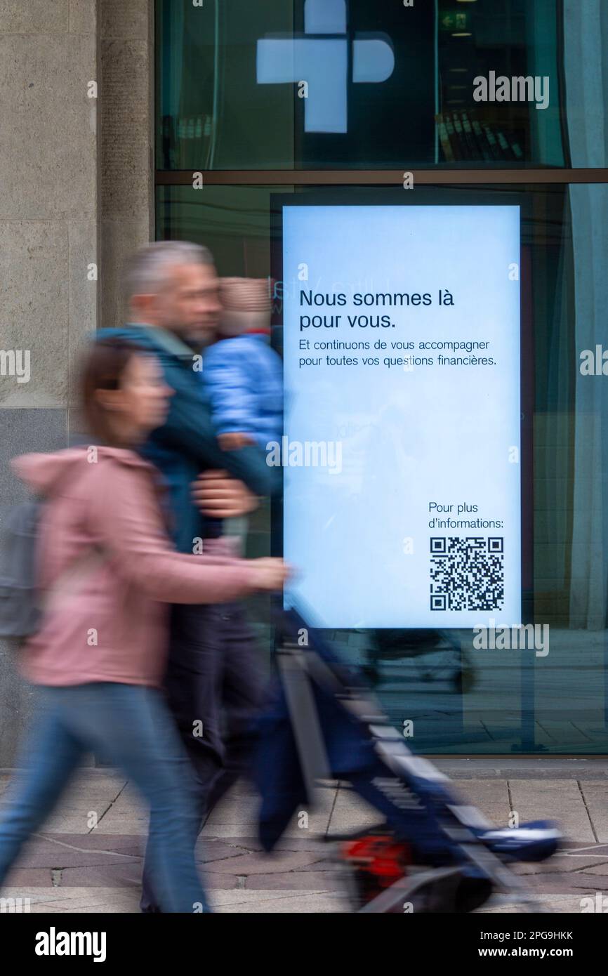 Signboards in the windows of the Credit Suisse main Geneva branch displays the message ' We are here for you'. The bank that was taken over by its rival UBS to prevent a cascading bank failure, is now trying to calm its customers who are worried about their money. Stock Photo
