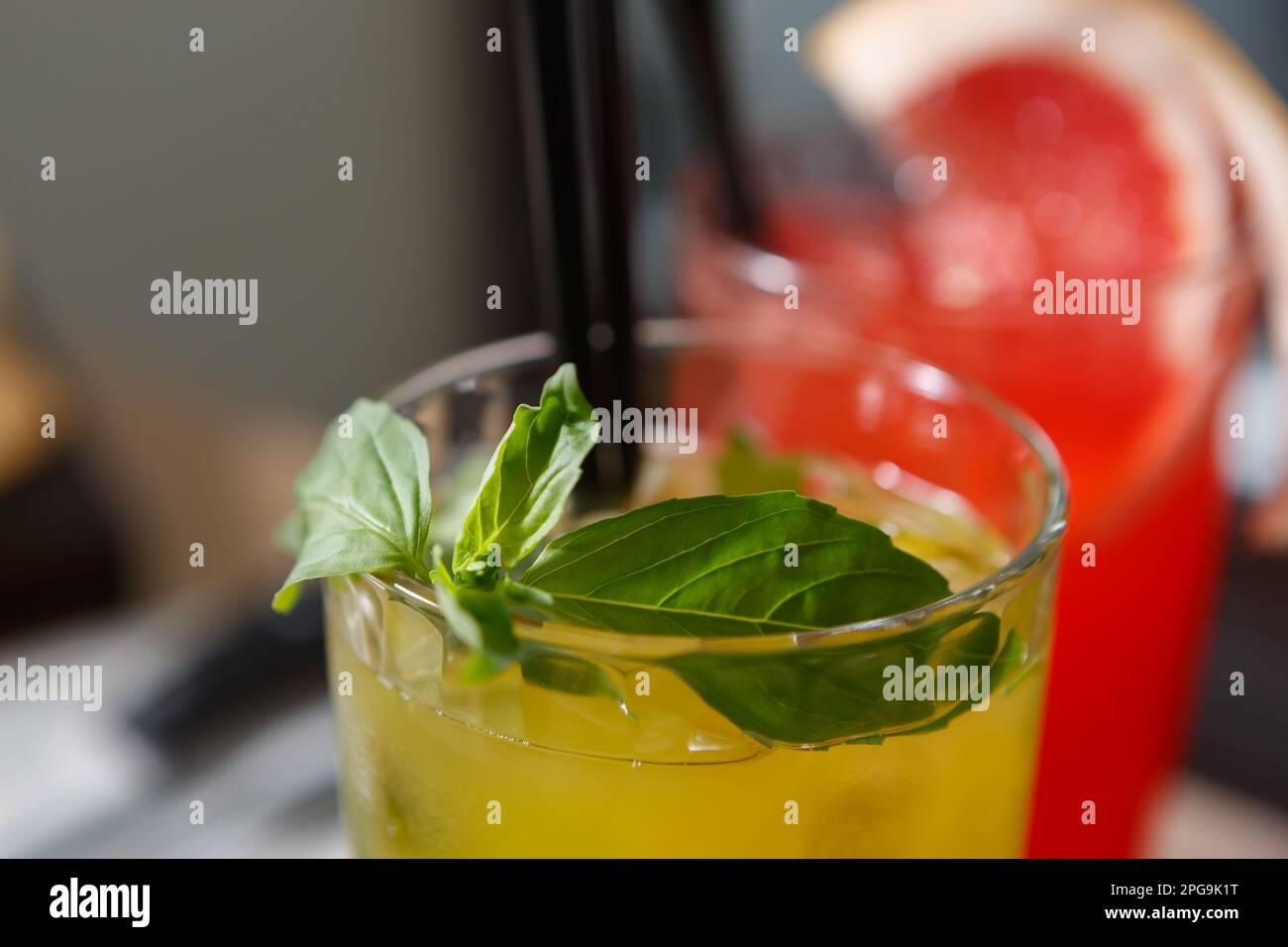 Traditional green mojto cocktail with fresh mint leaves, lemon lime and rum served in a bar. Refreshing summer long drink for a party Stock Photo