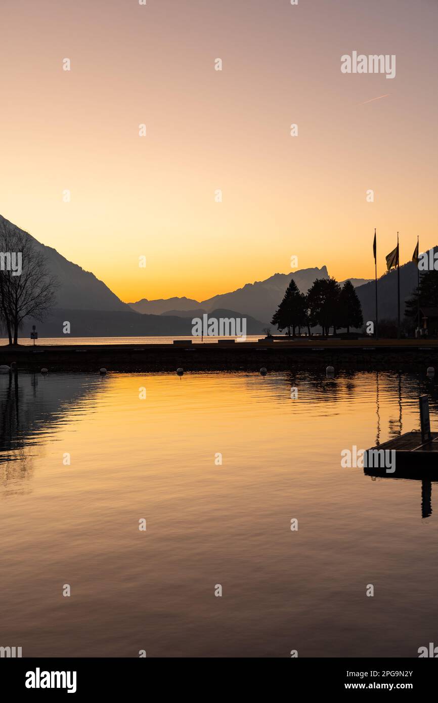 Unterseen, Canton Bern, Switzerland, February 12, 2023 Fantastic alpine landscape scenery just after sunset from the coast of the lake of Thun Stock Photo