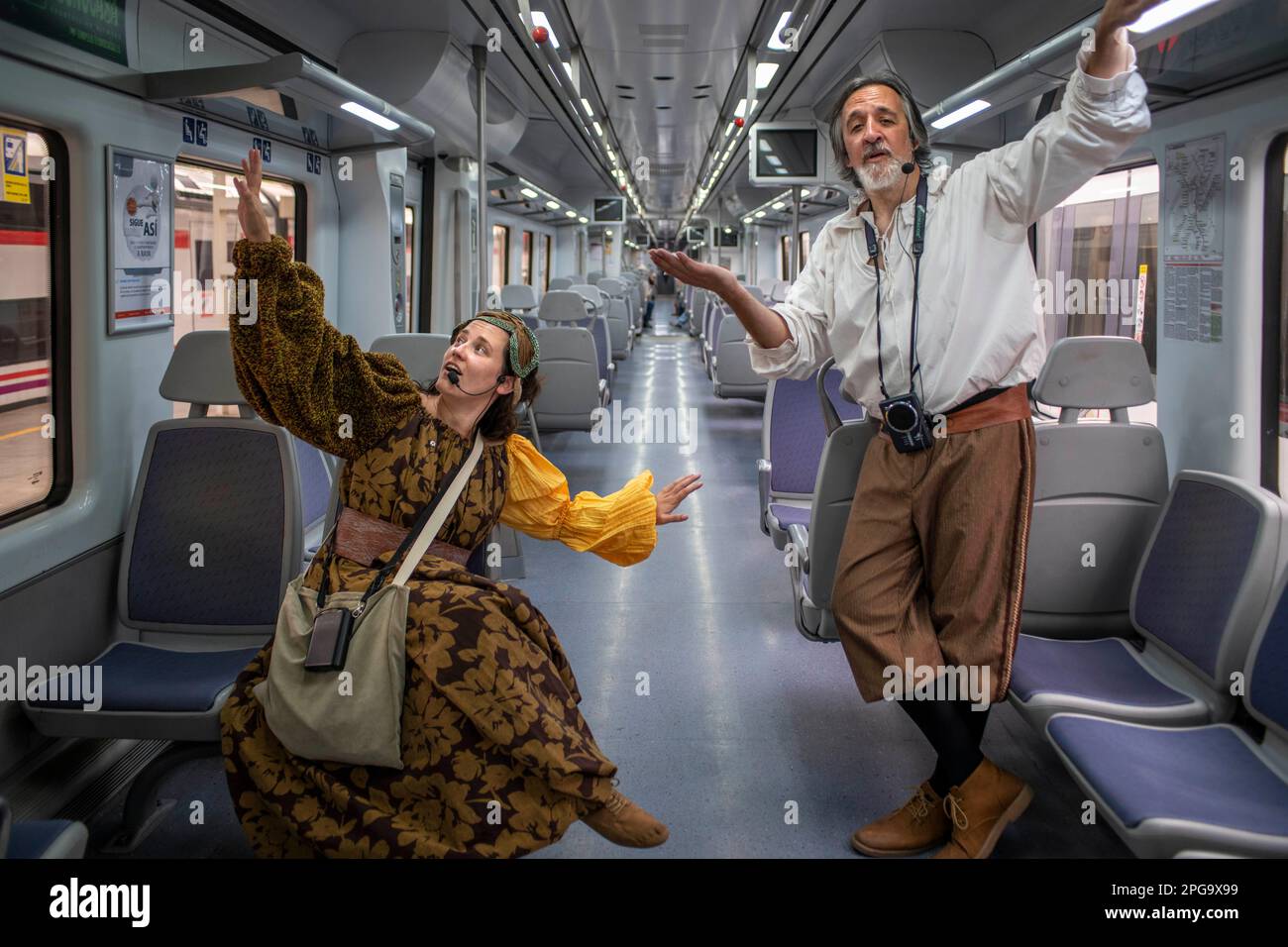 Actors performing Don Quixote de la Mancha and Dulcinea del Toboso inside the Cervantes Train between Atocha train Station and Alcala de Henares, Madr Stock Photo